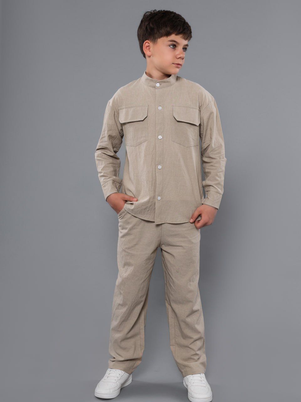 Boy in a beige washed-cotton shirt and trousers
